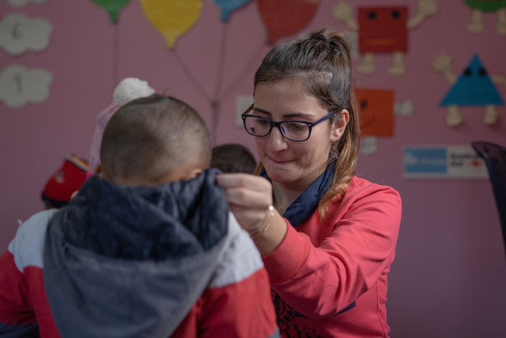 An educator helps a child at an inclusive school in Lebanon. (file photo)